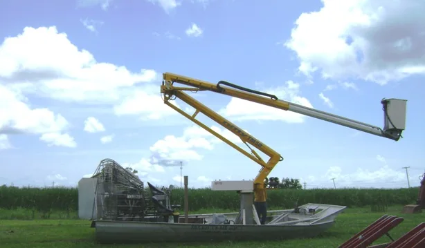 Faucheux airboat equipped with an elevated personnel basket