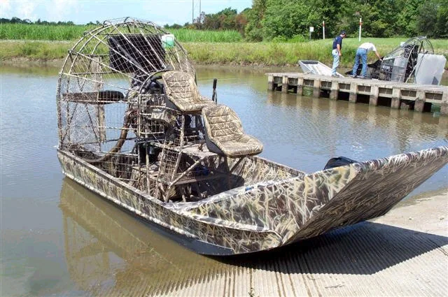 Custom-fabricated airboat beside a dock