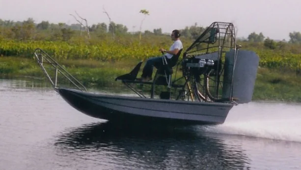 Historic Faucheux airboat moving across the water