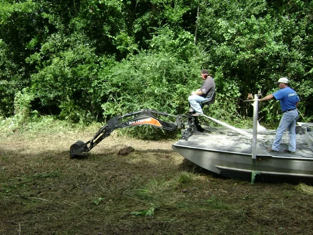 Pipeline airboat using mounted equipment at the water’s edge